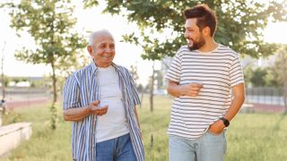 An older, shorter male talking to a younger, taller male