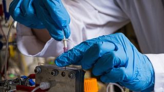 A person testing the reactor system prototype.